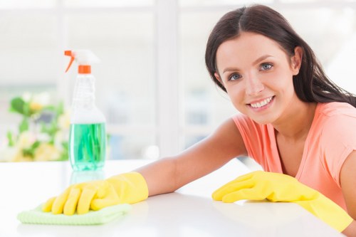 Cleaner in Wimbledon preparing safety equipment before a cleaning task