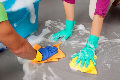Team member working carefully with cleaning tools while following safety standards