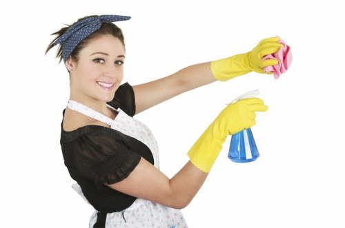 Professional cleaner preparing a Wimbledon short-let kitchen and living area