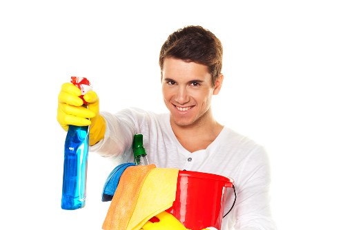 Professional cleaner wiping shared entrance surfaces in Wimbledon